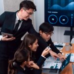 Finance professionals analysing business performance data