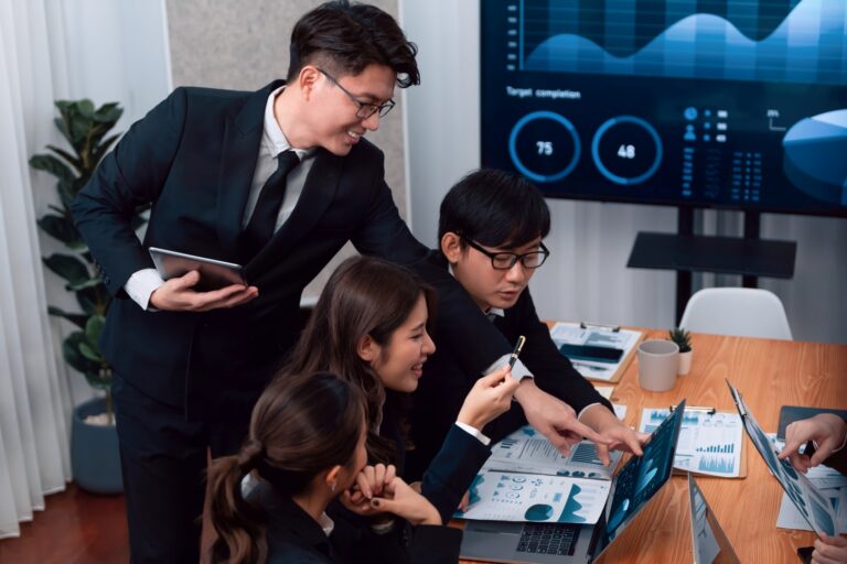 Finance professionals analysing business performance data